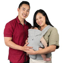 Load image into gallery viewer, A parents using the Caleo Charm Deluxe 3-in-1 Newborn Carrier to carry their baby
