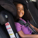 Load image into gallery viewer, A child sitting in the Baby Trend Hybrid Combination Booster Car Seat