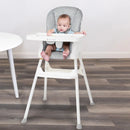 Load image into gallery viewer, A child is sitting in the Baby Trend Adapt 4-in-1 High Chair
