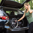 Load image into gallery viewer, A mom is putting the Baby Trend XCEL-R8 PLUS Jogger Stroller with LED into her car