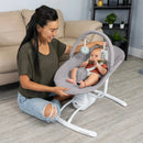 Load image into gallery viewer, A mom is watching her child sit in the Baby Trend Sit N' Sway Portable Swing