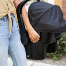 Load image into gallery viewer, A mom is carrying the Baby Trend EZ-Lift 35 Infant Car Seat by using the easy side grip for comfort