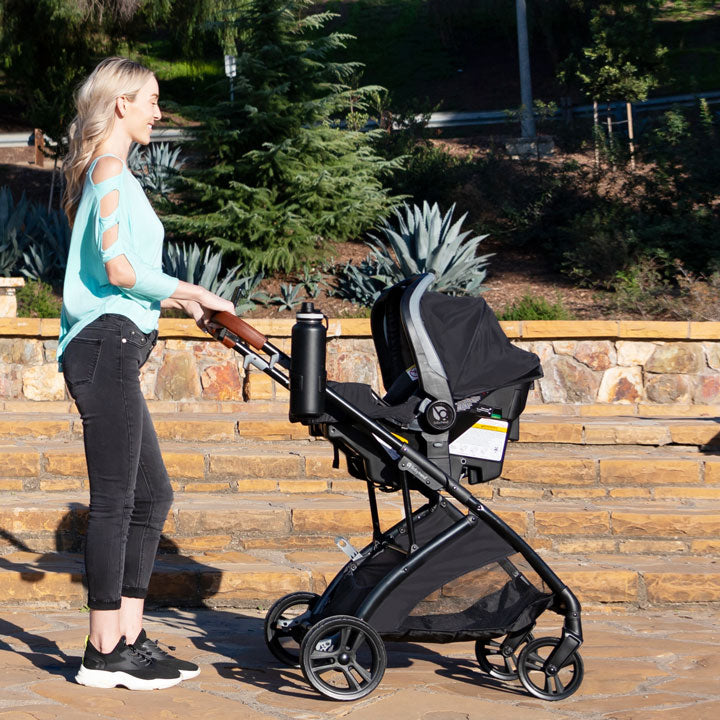 Baby Trend Sonar Switch Plus travel system with infant car seat mother pushing her child