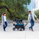 Load image into gallery viewer, Parents taking their two child on a stroll with the Baby Trend Expedition 2-in-1 Stroller Wagon PLUS