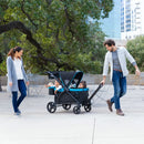 Load image into gallery viewer, Parents taking their two child on a stroll with the Baby Trend Expedition 2-in-1 Stroller Wagon PLUS