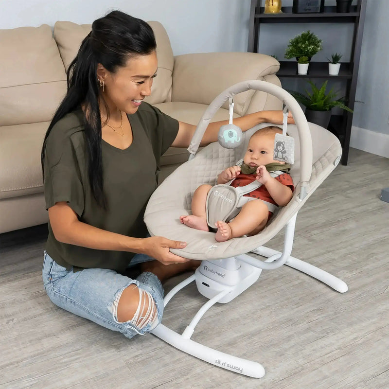 A mom is watching her child sit in the Baby Trend Sit N' Sway Portable Swing