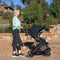 A mom is pushing her baby in the Baby Trend Passport Switch 6-in-1 Modular Stroller 