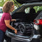 Mom is putting her Baby Trend stroller into the back of her car