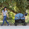 A mom is pulling her two children sitting in the Navigator 2-in-1 Stroller Wagon