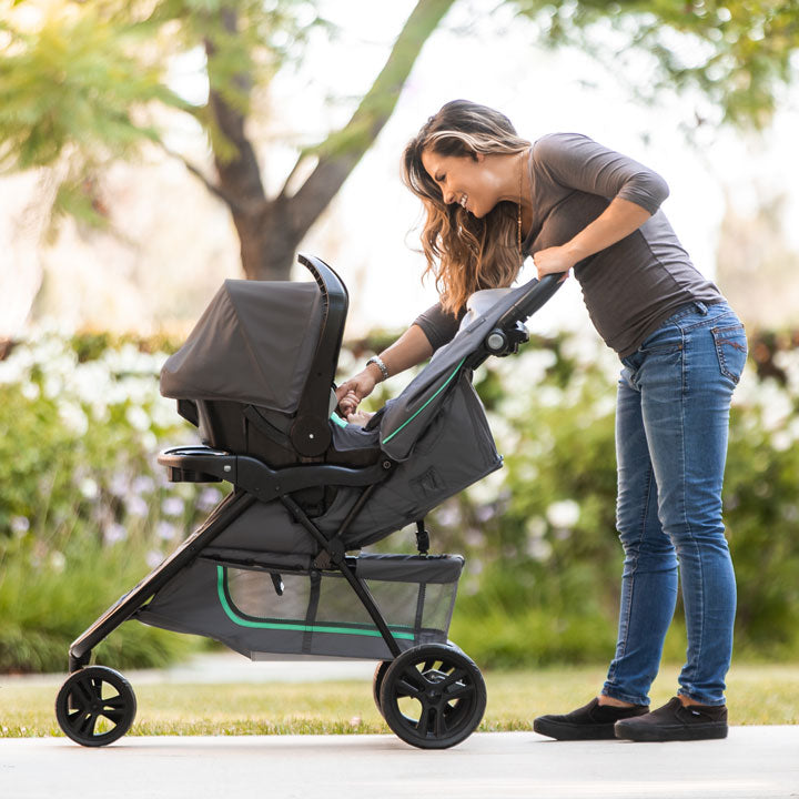 Baby Trend EZ Ride Travel System with EZ-Lift 35  Infant Car Seat 3 wheel travel system with mother taking care of her infant