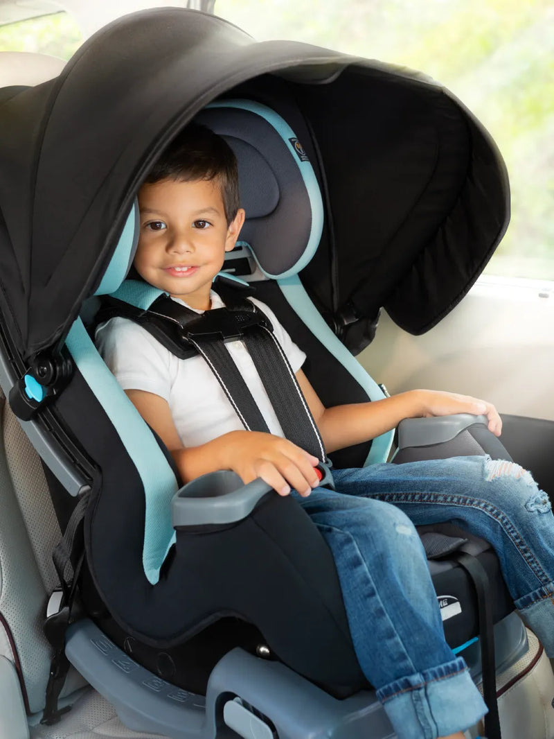 A child is sitting in the Cover Me Convertible Car Seat