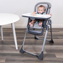 Load image into gallery viewer, Baby is snacking while sitting on the Baby Trend Sit Right 2.0 3-in-1 High Chair