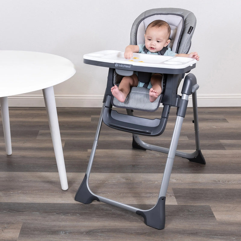 Baby is snacking while sitting on the Baby Trend Sit Right 2.0 3-in-1 High Chair