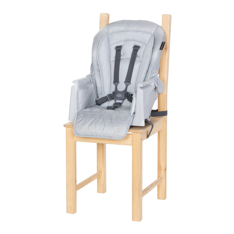 Baby Trend Everlast 7-in-1 High Chair in toddler booster mode on a chair