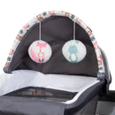 Load image into gallery viewer, Two hanging toys on the napper included in the Baby Trend Lil’ Snooze Deluxe II Nursery Center Playard