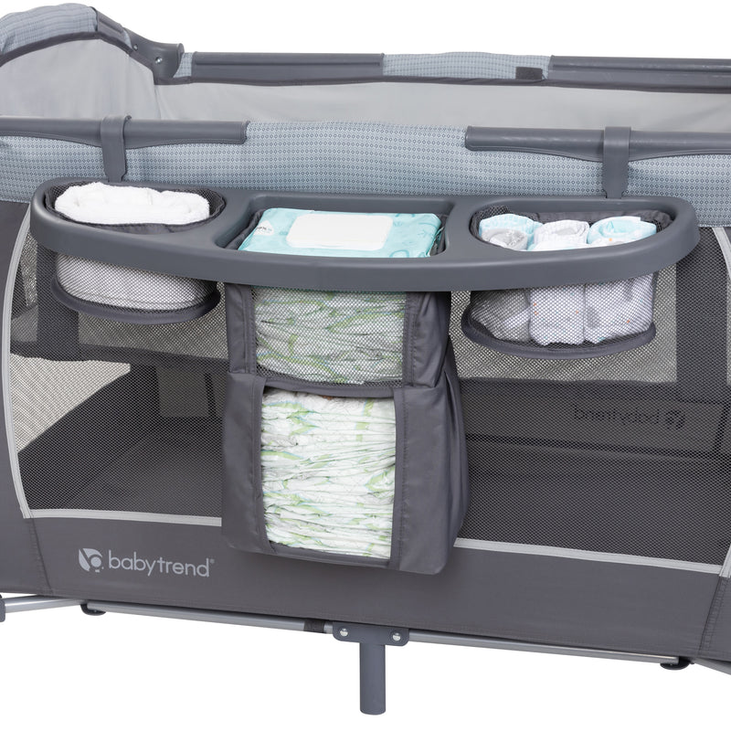 Baby Trend Lil’ Snooze Deluxe III Nursery Center Playard for Twins includes deluxe parent organizer for diapers and wipes