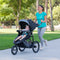 Mother jogging with her child in the innovative Baby Trend Expedition Race Tec Plus Jogger Stroller