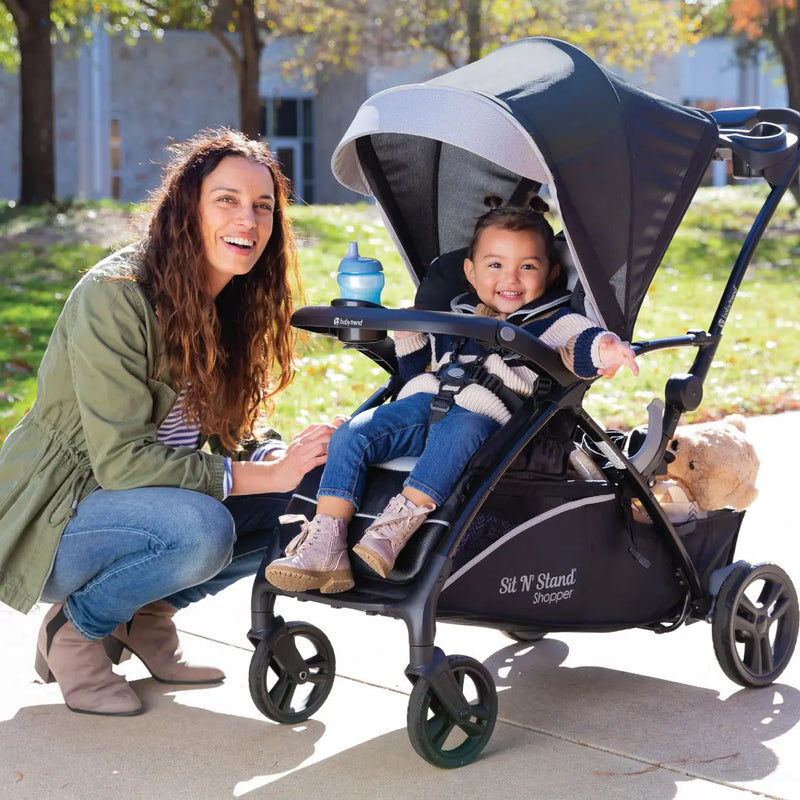 Baby Trend Sit N Stand 5-in-1 Shopper Stroller of mom and child riding in the front seat