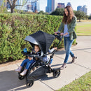 Load image into gallery viewer, Baby Trend Sit N Stand 5-in-1 Shopper Stroller with mother and two children in one stroller