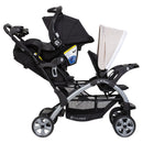 Load image into gallery viewer, Baby Trend Sit N' Stand Double Stroller side view of child front seat and rear seat being used as a travel system with an infant car seat