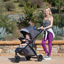 Load image into gallery viewer, Mother is strolling with her child outdoor in the Baby Trend Tango 3 All-Terrain Stroller Travel System